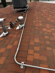 Electrical conduit installed across a shingled roof, part of a project by Flores power solutions in El Paso, TX.