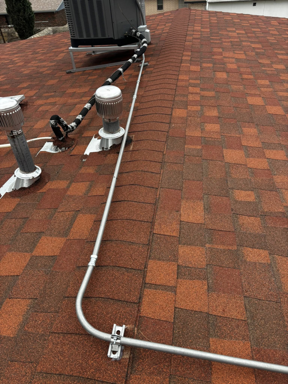 Electrical conduit installed across a shingled roof, part of a project by Flores power solutions in El Paso, TX.
