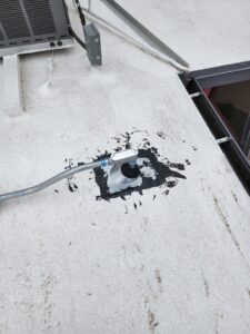 Electrical conduit penetrating a white roof, properly sealed, installed by CDB Electrical LLC in Tucson, AZ.