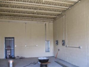 Electrical conduits and junction boxes installed on walls during rough-in in a commercial building by Argosy Electric, Inc. in Newport News, VA