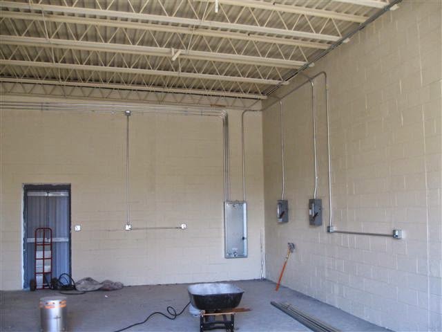 Electrical conduits and junction boxes installed on walls during rough-in in a commercial building by Argosy Electric, Inc. in Newport News, VA