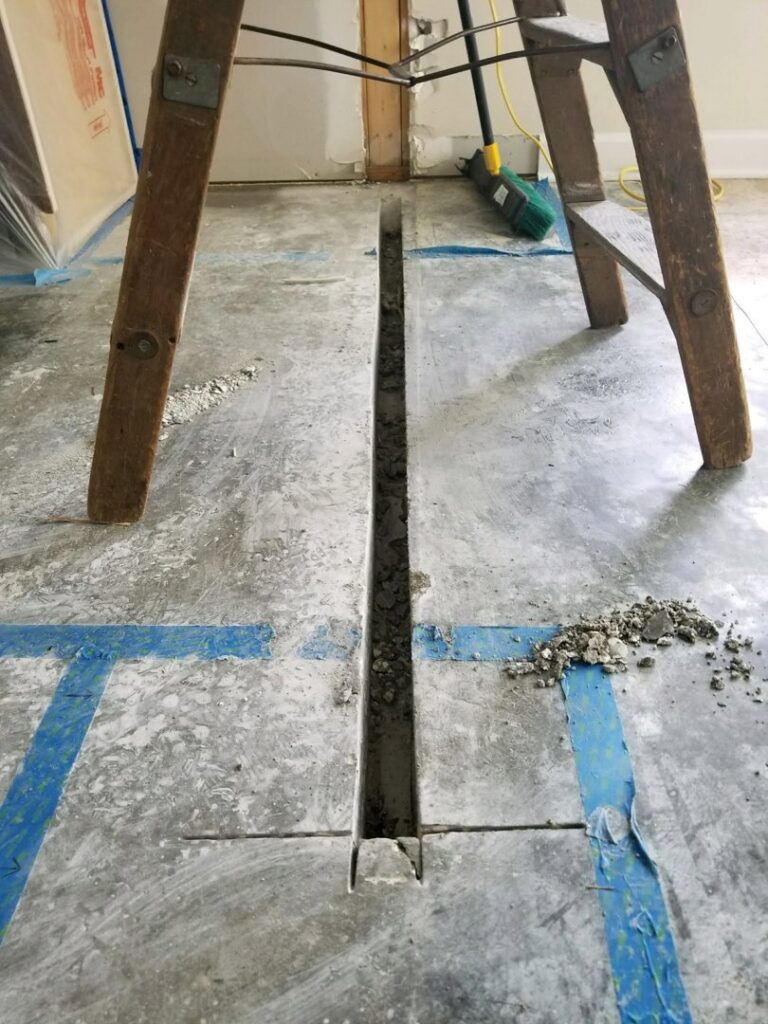 Trenching in a concrete floor for electrical conduit installation by OceanSide Electric in Hilton Head Island, SC.