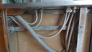 Electrical conduits and wiring installed inside a wall during construction by Positricity in Clearwater, FL.