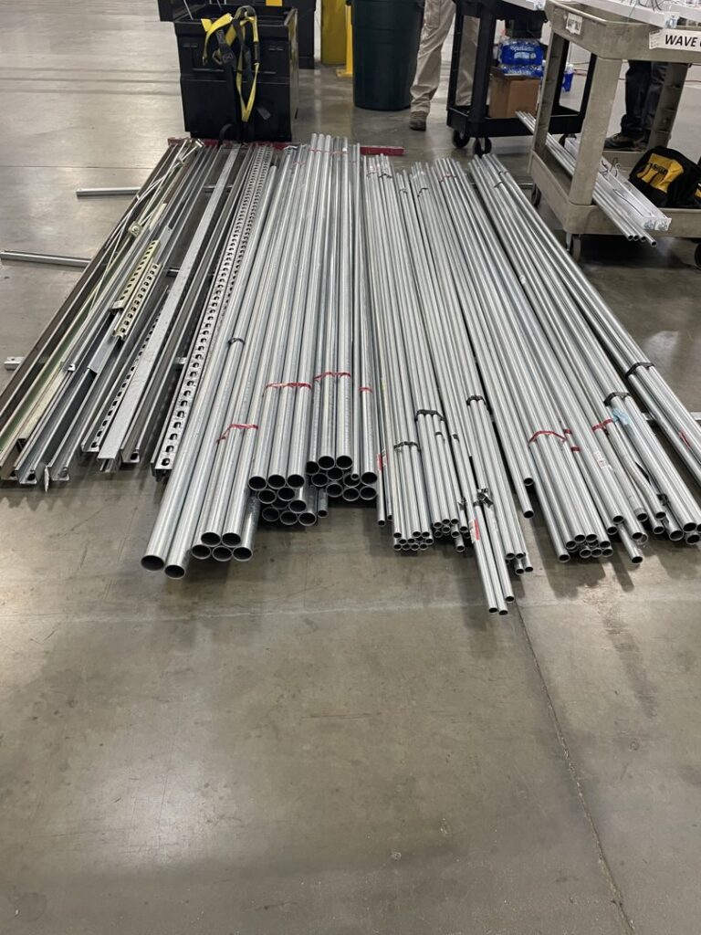 A pile of metal electrical conduits and channels, materials used by Ernco Electric Inc. for installations in Fresno, CA.