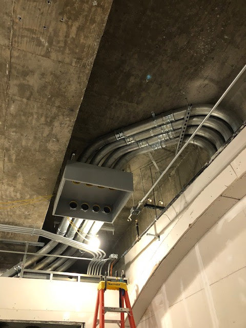 Electrical conduits and junction boxes installed on a ceiling at a job site by RD Graham Electric, LLC in Greensboro, NC.