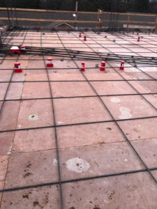 Electrical conduits and rebar laid out on a concrete slab for new construction by MVL Electric, LLC in Atlanta, GA