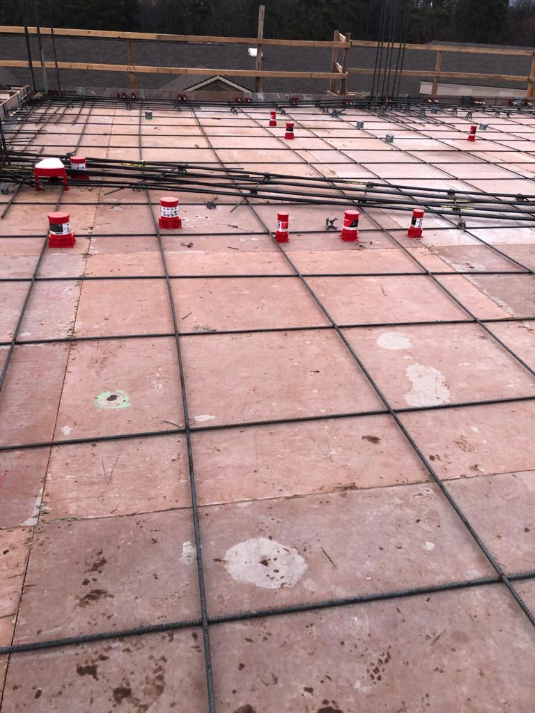 Electrical conduits and rebar laid out on a concrete slab for new construction by MVL Electric, LLC in Atlanta, GA