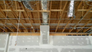 Electrical conduits and wiring installed across the ceiling of a commercial building under construction by Ready Electric 24/7 in Knoxville, TN.