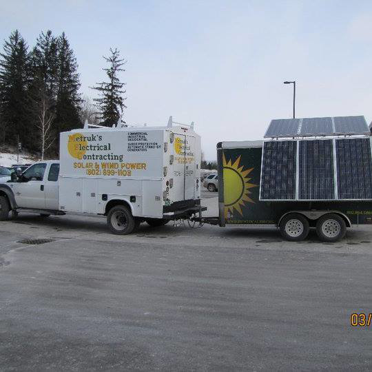 Metruk's Electrical Contracting, Inc. truck towing a solar power trailer in Underhill, VT.