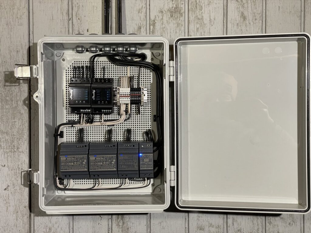 An open electrical control box showing intricate wiring and modules installed by Kot Electric LLC in Kent, WA.