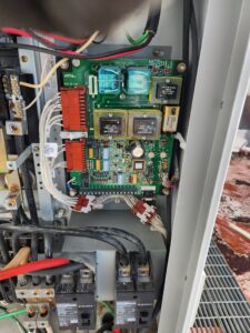 An open electrical control panel revealing circuit boards and wiring, serviced by Tim Lambert Electric in Fayetteville, NC.