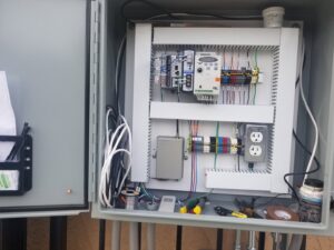 Close-up of an electrical control panel with intricate wiring and components installed by J&L Electric Inc. in San Antonio, TX