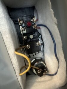 Close-up of electrical wiring, relays, and terminals inside a control panel, serviced by McNeal and Sons Electrical and HVAC in Birmingham, AL.