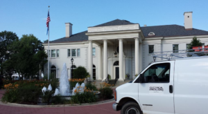 An Electrical Dimensions, Inc. service van with a ladder rack parked at a commercial job site in Verona, WI.
