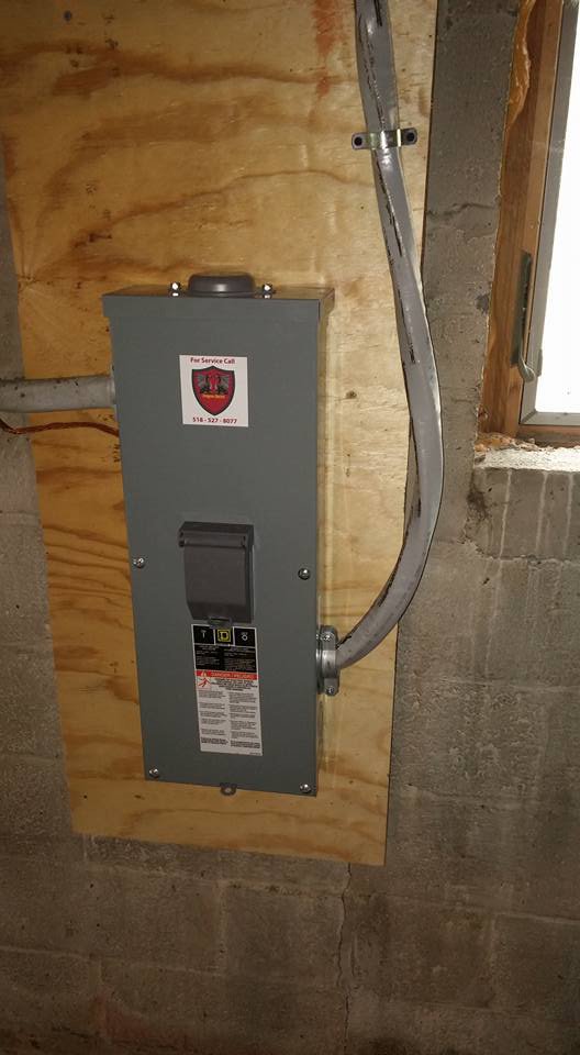 An electrical disconnect box installed on a wooden panel by Dragons Electric in Schenectady, NY