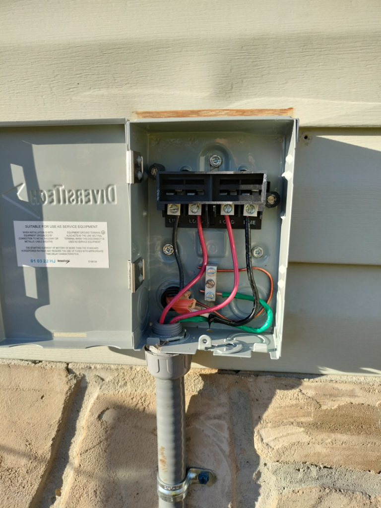An open electrical disconnect box with new wiring installed by Devin Parker Electric in Knoxville, TN