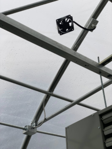 An electrical fan and conduit system installed on the ceiling of a greenhouse by Hulett Electric & Father in Shaftsbury, VT.