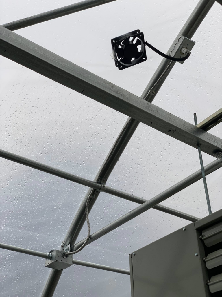 An electrical fan and conduit system installed on the ceiling of a greenhouse by Hulett Electric & Father in Shaftsbury, VT.