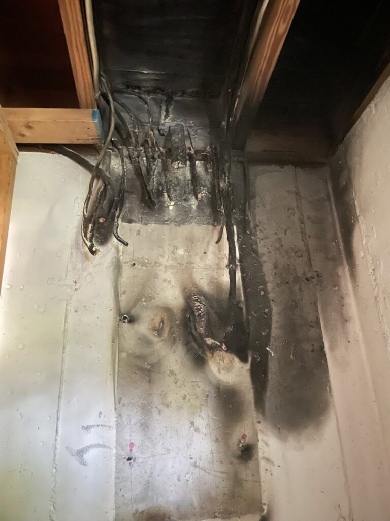 Evidence of electrical fire damage on a wall and wiring, requiring repair from J. Bathe Electric in Saint Charles, MO.