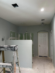 Various electrical fixtures, including recessed lights, being installed in a room under construction by Break-N-Run Services in Henderson, NV.