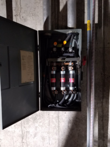 A close-up view of an electrical fuse box installation with visible wiring, performed by Zuz Electric in Houston, TX.