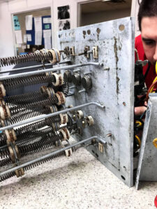 Close-up of electrical heating elements and wiring inside a unit being repaired by Ace Electric Inc. in Valdosta, GA.