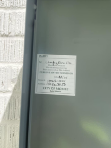 An official electrical inspection sticker from the City of Mobile, showing approval for Charging Rhino Electric in Mobile, AL