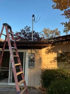 An exterior view of a new electrical mast and meter box installation on a house by Innovate Electric in Earth City, MO.
