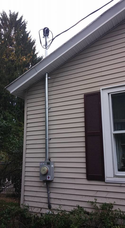 An electrical mast and meter installed on the exterior of a home by Dragons Electric in Schenectady, NY