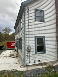 Exterior electrical meter and conduit installed on the side of a house by Clemens Electric in Averill Park, NY