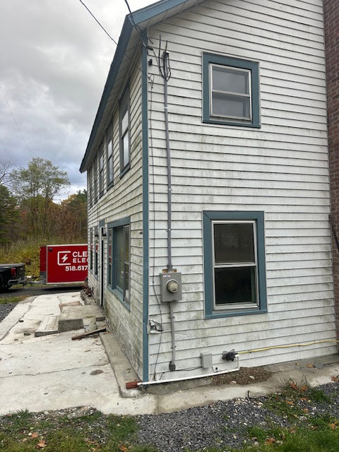 Exterior electrical meter and conduit installed on the side of a house by Clemens Electric in Averill Park, NY