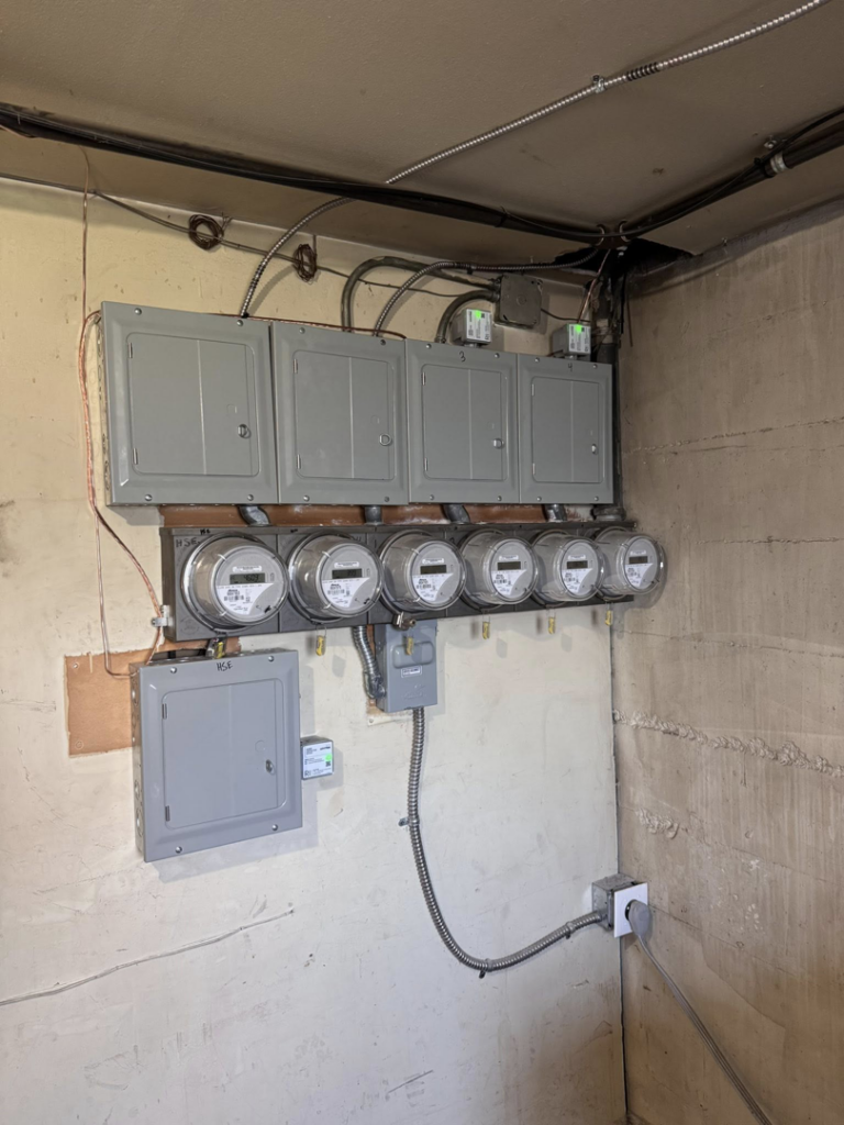 Multiple electrical meters and circuit breaker panels professionally installed by OCD Electric in Spokane, WA.