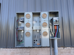 An outdoor electrical meter bank installation on a commercial building by Polsley Electric Company in Omaha, NE