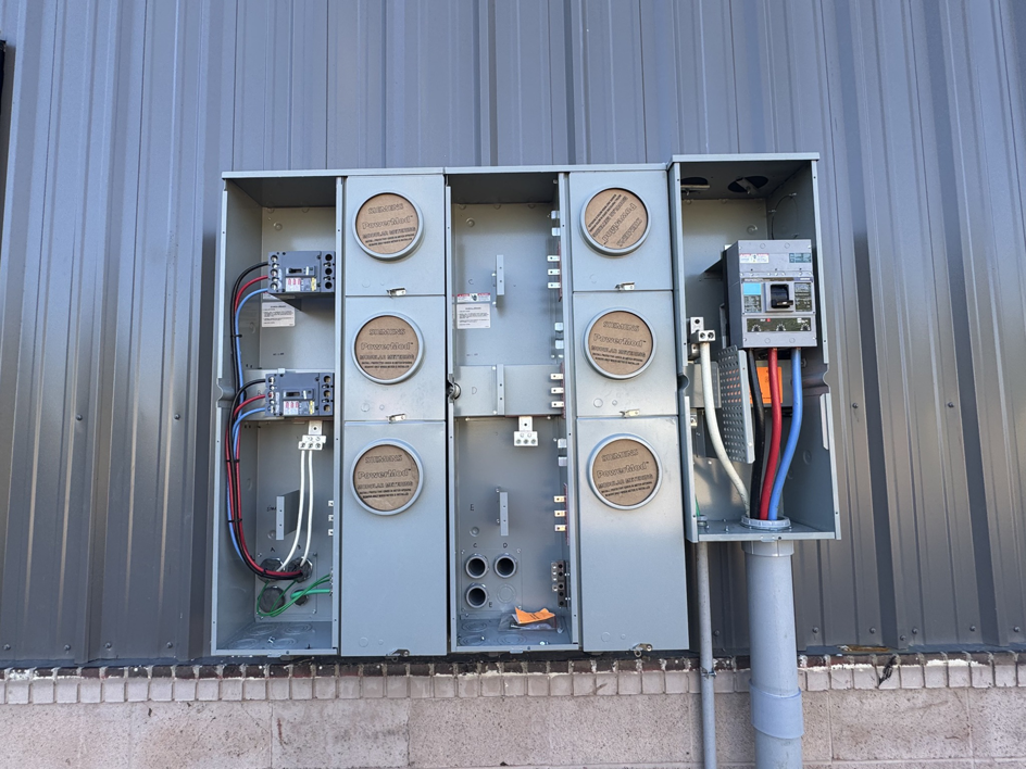 An outdoor electrical meter bank installation on a commercial building by Polsley Electric Company in Omaha, NE
