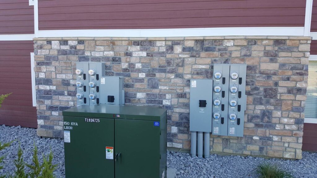 Exterior of apartment building with electrical meters and transformer installed by Safehouse Electric Company in Blue Springs, MO.
