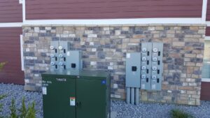 Exterior of apartment building with electrical meters and transformer installed by Safehouse Electric Company in Blue Springs, MO.