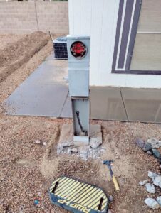 An electrical meter base installation with conduit and wiring in the ground by Johnson Power and Air in Gilbert, AZ.