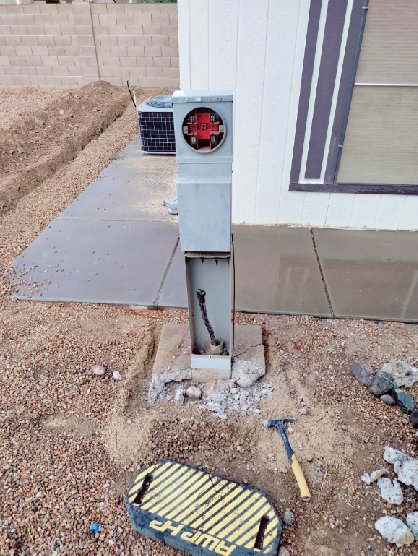 An electrical meter base installation with conduit and wiring in the ground by Johnson Power and Air in Gilbert, AZ.