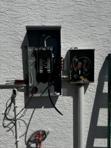 An open electrical meter base and main breaker panel with exposed wiring, showing work in progress by Flores power solutions in El Paso, TX.