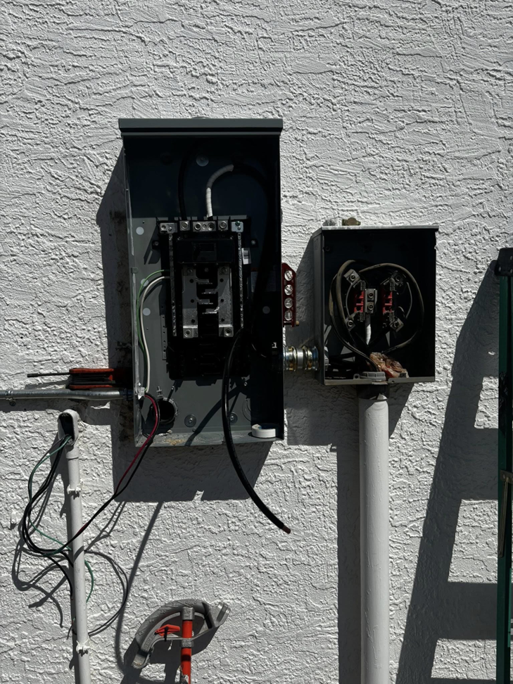 An open electrical meter base and main breaker panel with exposed wiring, showing work in progress by Flores power solutions in El Paso, TX.