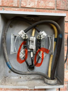 Close-up view of electrical meter base wiring and connections by Tony James Electrical service in Houma, LA.