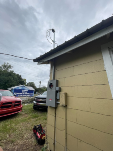 An electrical meter box and conduit installed on the side of a house by Greater Baton Rouge Electric in Baton Rouge, LA.