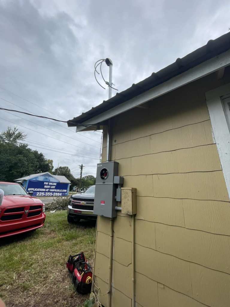 An electrical meter box and conduit installed on the side of a house by Greater Baton Rouge Electric in Baton Rouge, LA.
