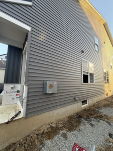 An electrical meter box installed on the exterior of a new construction home by Mark Anthony Electric LLC in Wilmington, DE
