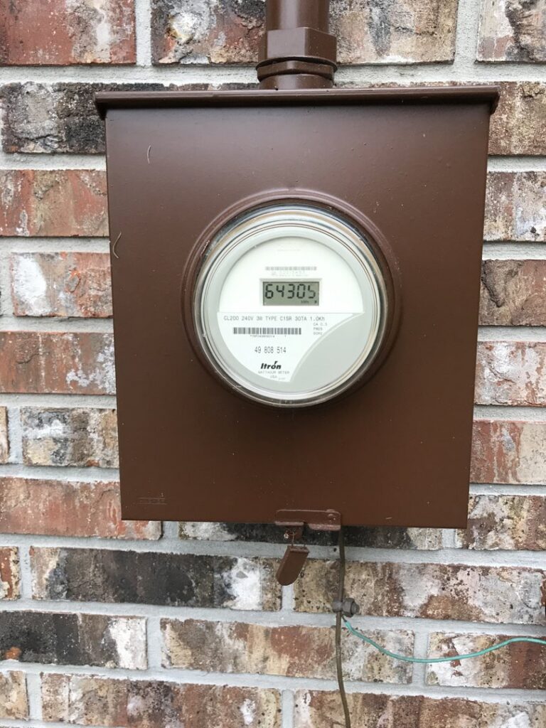An electrical meter box installed on a brick wall, serviced by Panama Electric Inc. in Jacksonville, FL.
