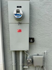 An exterior electrical meter and disconnect panel installed by Bee Electrical Contracting in Port Saint Lucie, FL.
