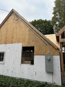 An exterior view of a building showing a newly installed electrical meter and conduit by Eriginal Electric LLC in Waterbury, CT.