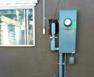 An electrical meter panel and conduit installed on the exterior of a building by Certified Electrician Albuquerque NM.