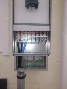 Close-up of an electrical meter panel with wiring connections by Icon West Corporation Electrical Contractors in Springfield, MA.