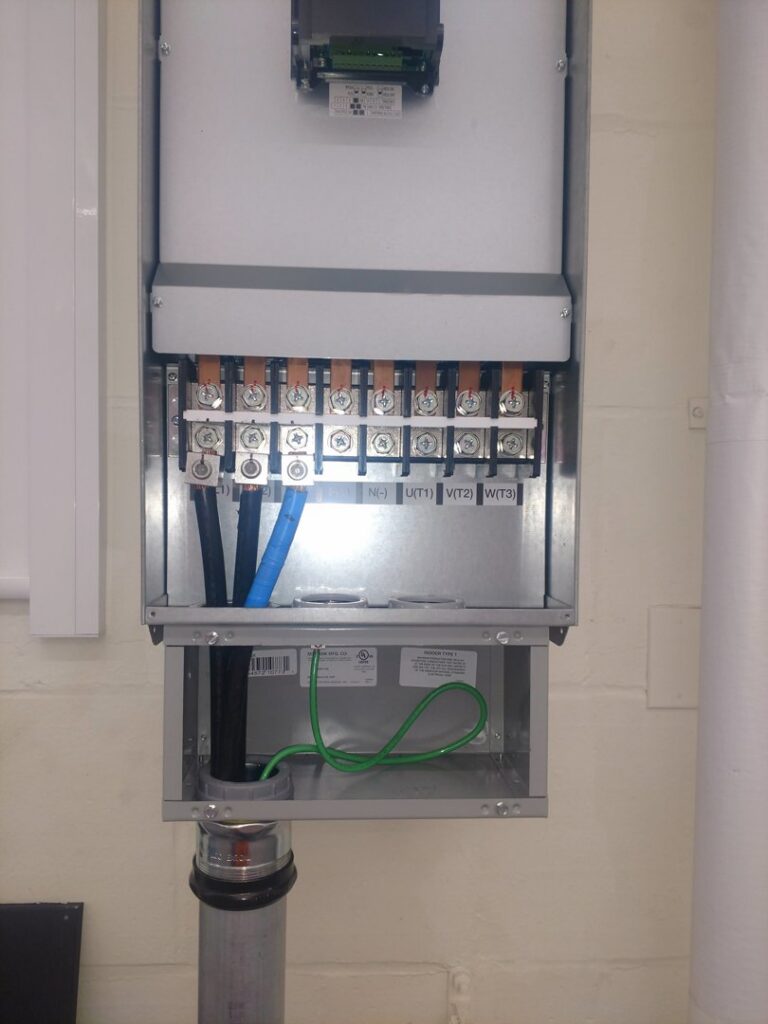 Close-up of an electrical meter panel with wiring connections by Icon West Corporation Electrical Contractors in Springfield, MA.